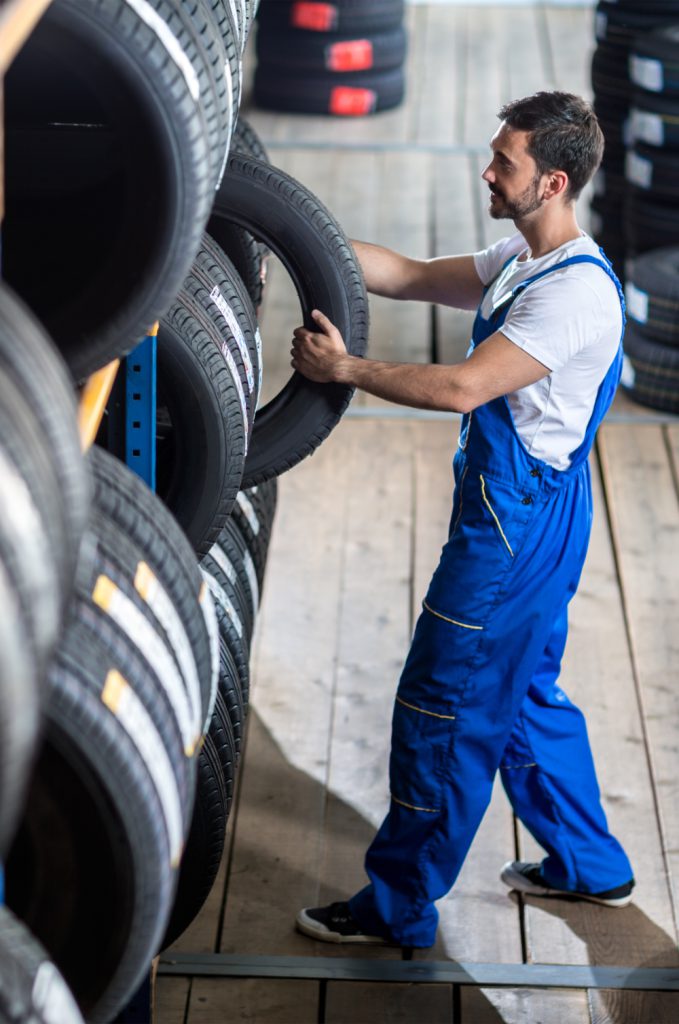 Mechanic taking a tyre from stock - Tyres Crieff